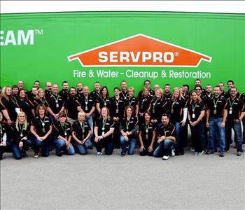 SERVPRO employees smiling infront of semi