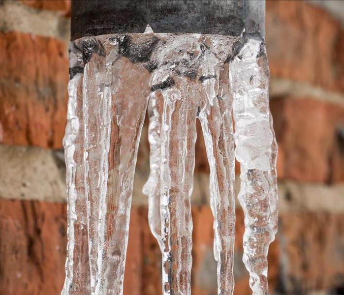 Frozen water coming out of a pipe.