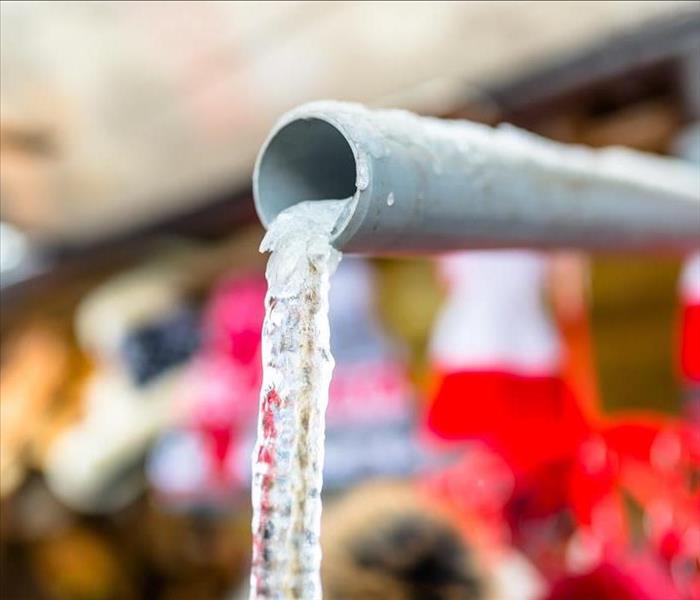 Frozen water coming out of a pipe.